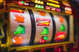 Live dealer at roulette table, spinning the wheel while players watch via stream